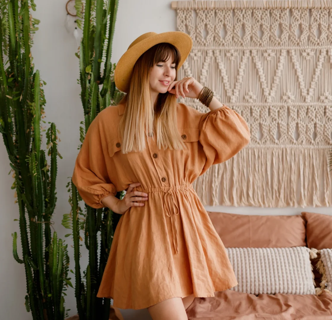 lovely-woman-linen-dress-straw-hat-posing-boho-style-apartment